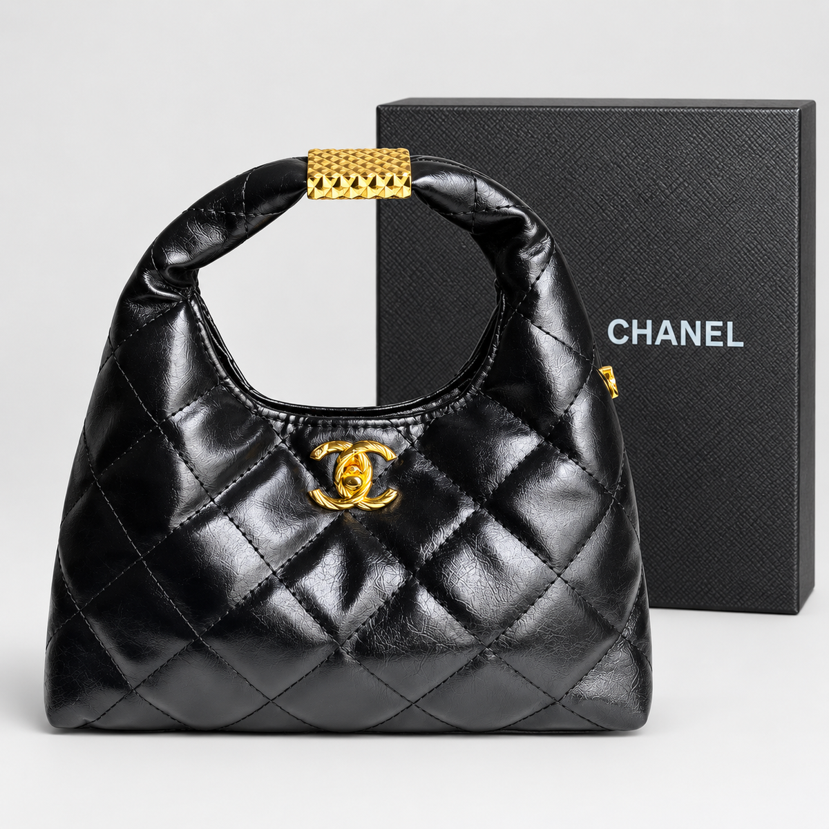 Chanel Quilted Black Hobo-Style Bag with Gold-Tone Handle Accent حقيبة شانيل سوداء مبطنة بنمط هوبو مع زينة ذهبية على المقبض